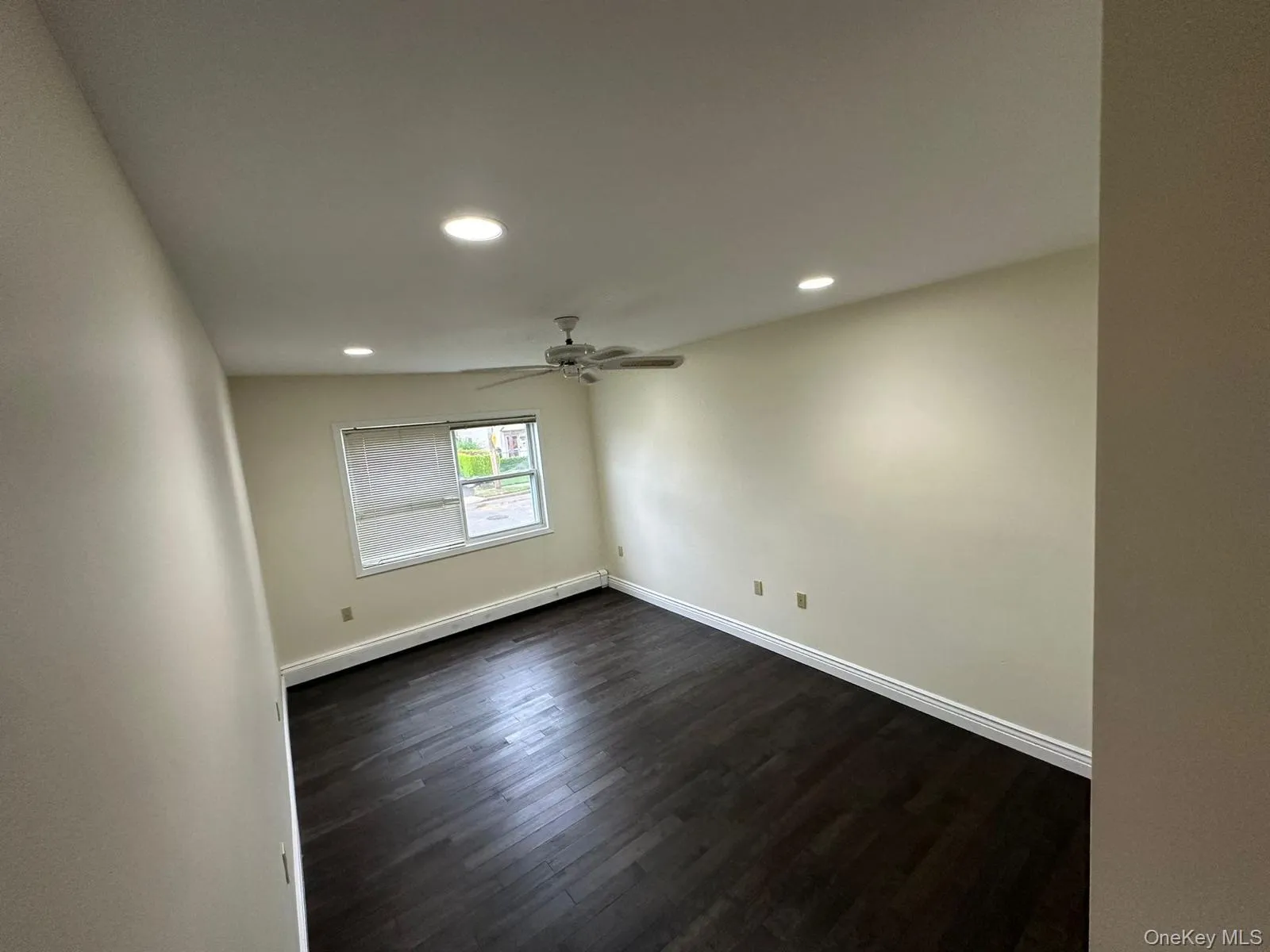 Unfurnished room with dark wood-style flooring, recessed lighting, and ceiling fan Unfurnished room with dark wood-style flooring, recessed lighting, and ceiling fan