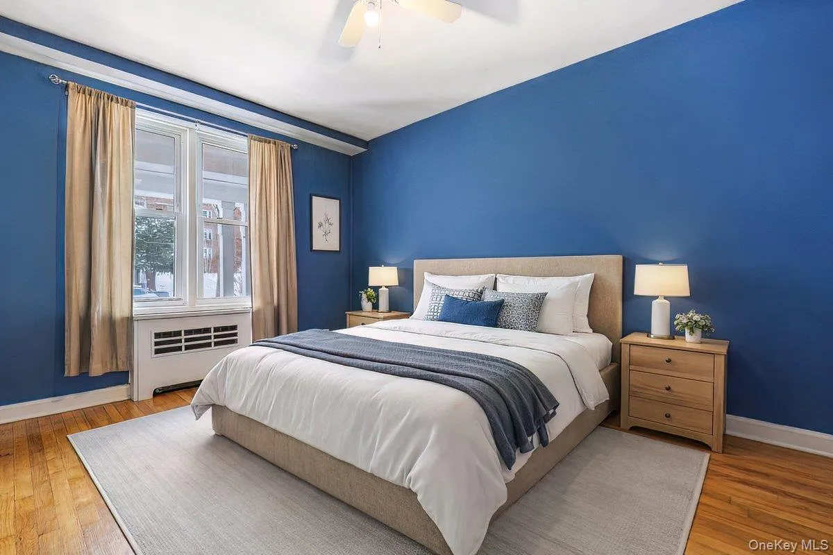 Bedroom with hardwood / wood-style flooring, a ceiling fan, and a wall unit AC Bedroom with hardwood / wood-style flooring, a ceiling fan, and a wall unit AC