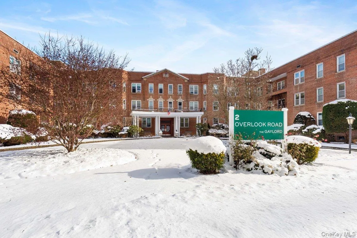 Snow covered building with a view of apartment building / complex Snow covered building with a view of apartment building / complex