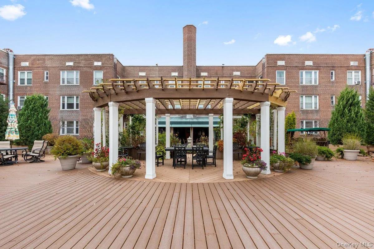 Deck featuring outdoor dining area and a pergola Deck featuring outdoor dining area and a pergola