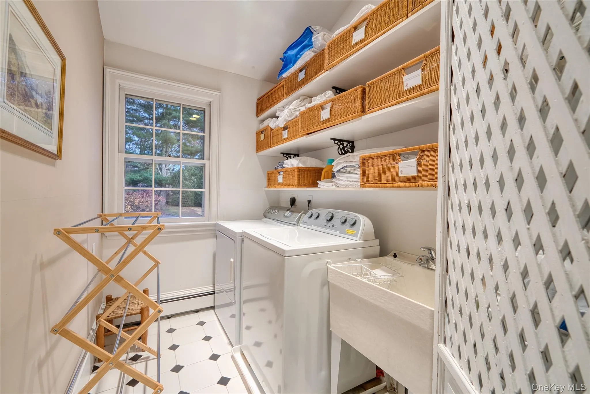 Laundry room with light floors and washing machine and clothes dryer Laundry room with light floors and washing machine and clothes dryer