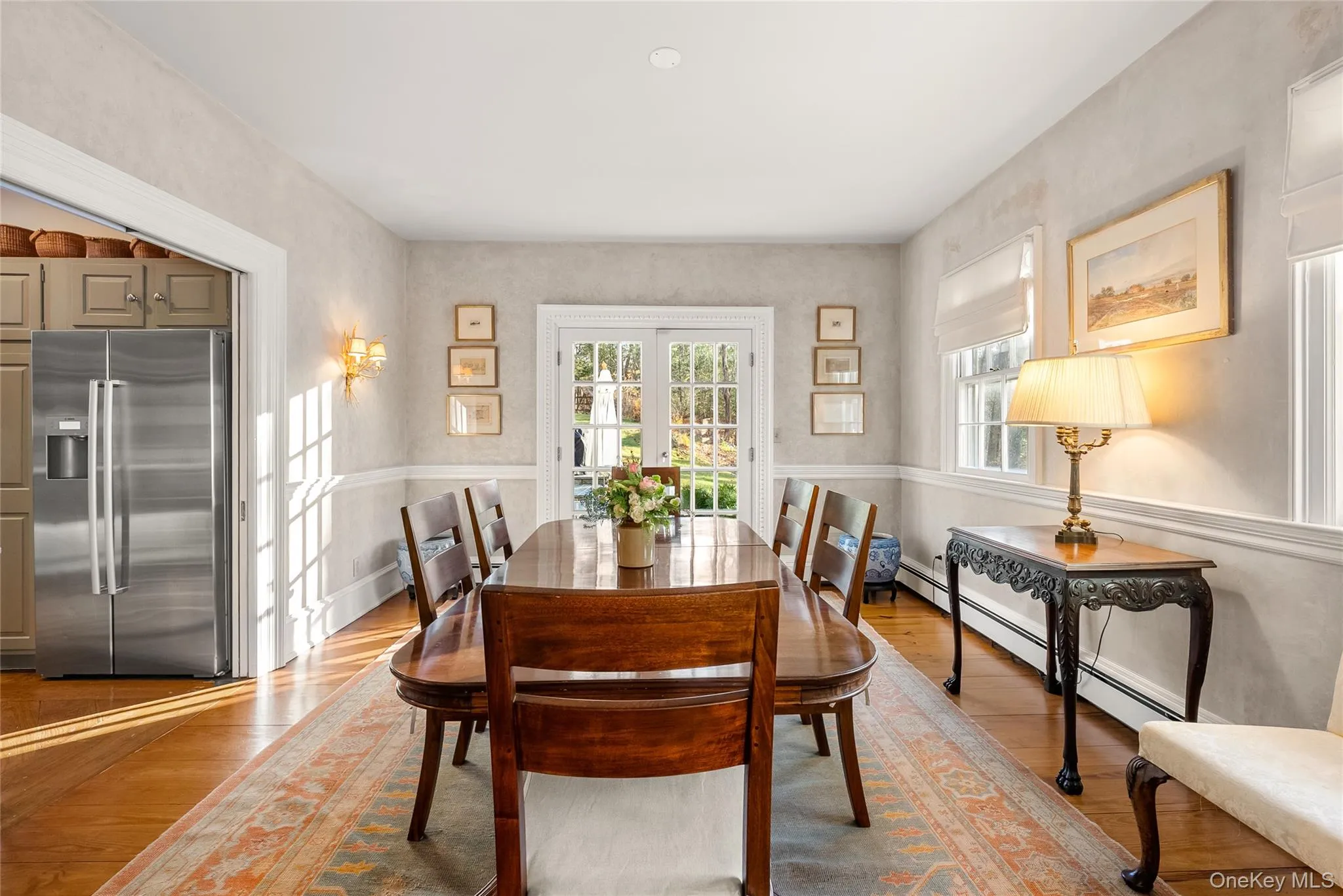 Dining area featuring hardwood / wood-style flooring, and french doors Dining area featuring hardwood / wood-style flooring, and french doors