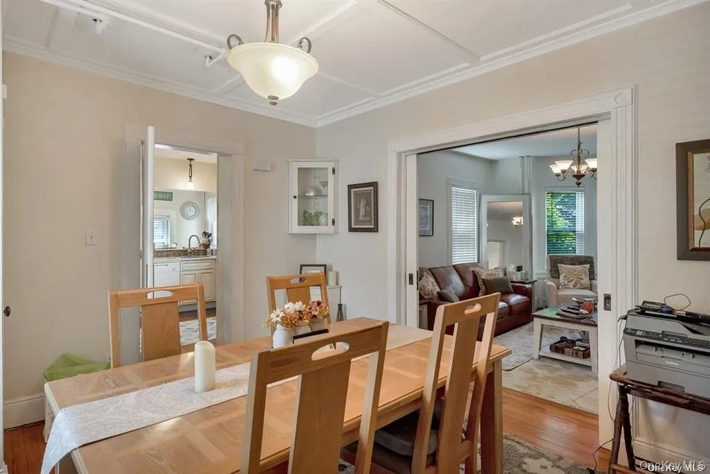 Dining room featuring wood finished floors and a chandelier Dining room featuring wood finished floors and a chandelier
