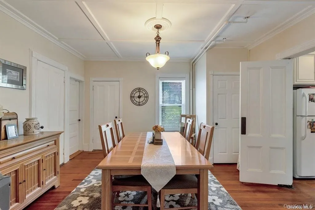 Dining space with dark wood finished floors Dining space with dark wood finished floors