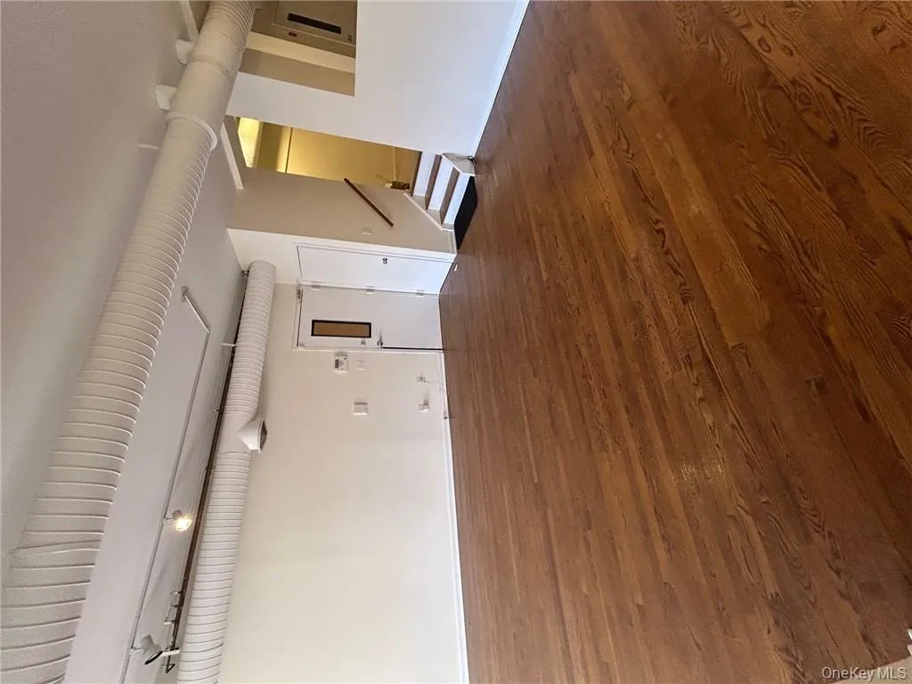 Unfurnished room featuring dark wood-type flooring Unfurnished room featuring dark wood-type flooring