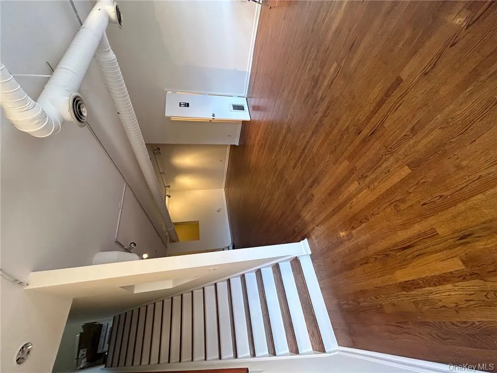 Unfurnished living room with dark hardwood / wood-style floors Unfurnished living room with dark hardwood / wood-style floors