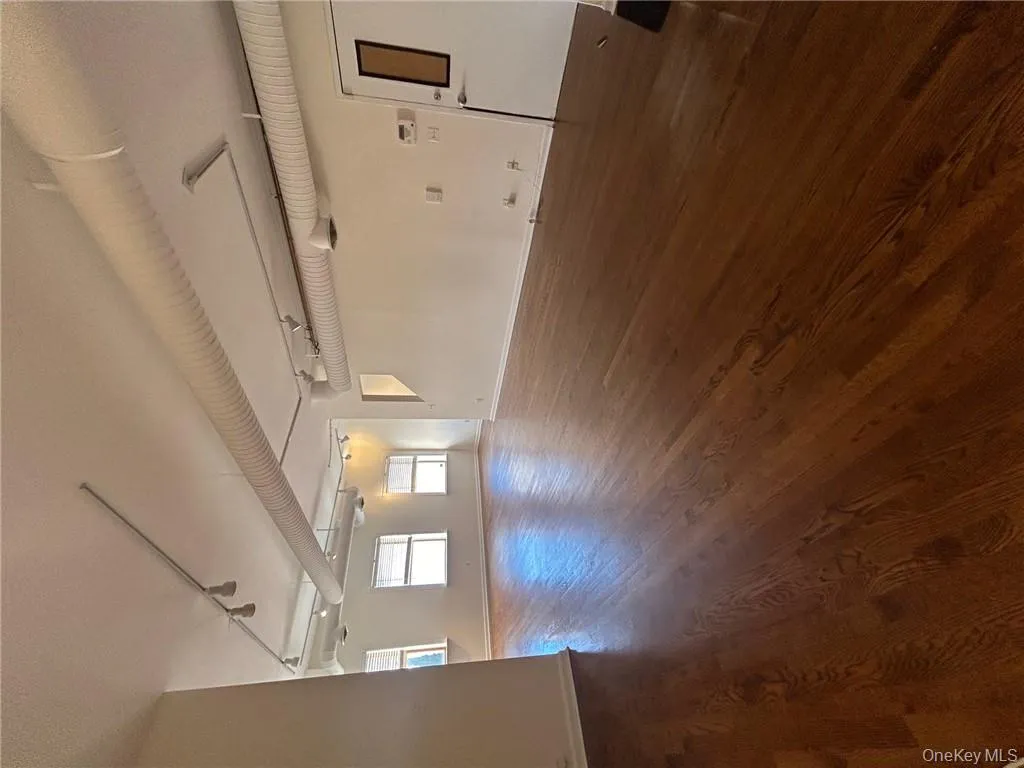 Spare room with dark wood-type flooring and rail lighting Spare room with dark wood-type flooring and rail lighting