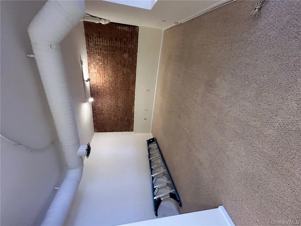 Basement with brick wall and carpet floors Basement with brick wall and carpet floors