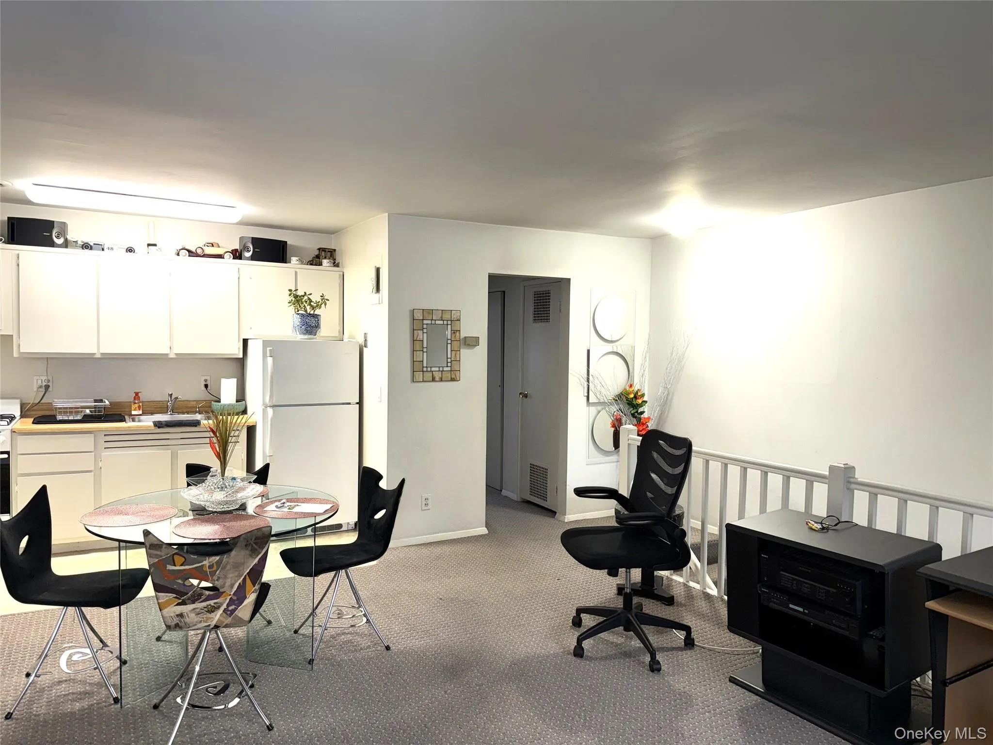 Living area with light carpet and baseboards Living area with light carpet and baseboards