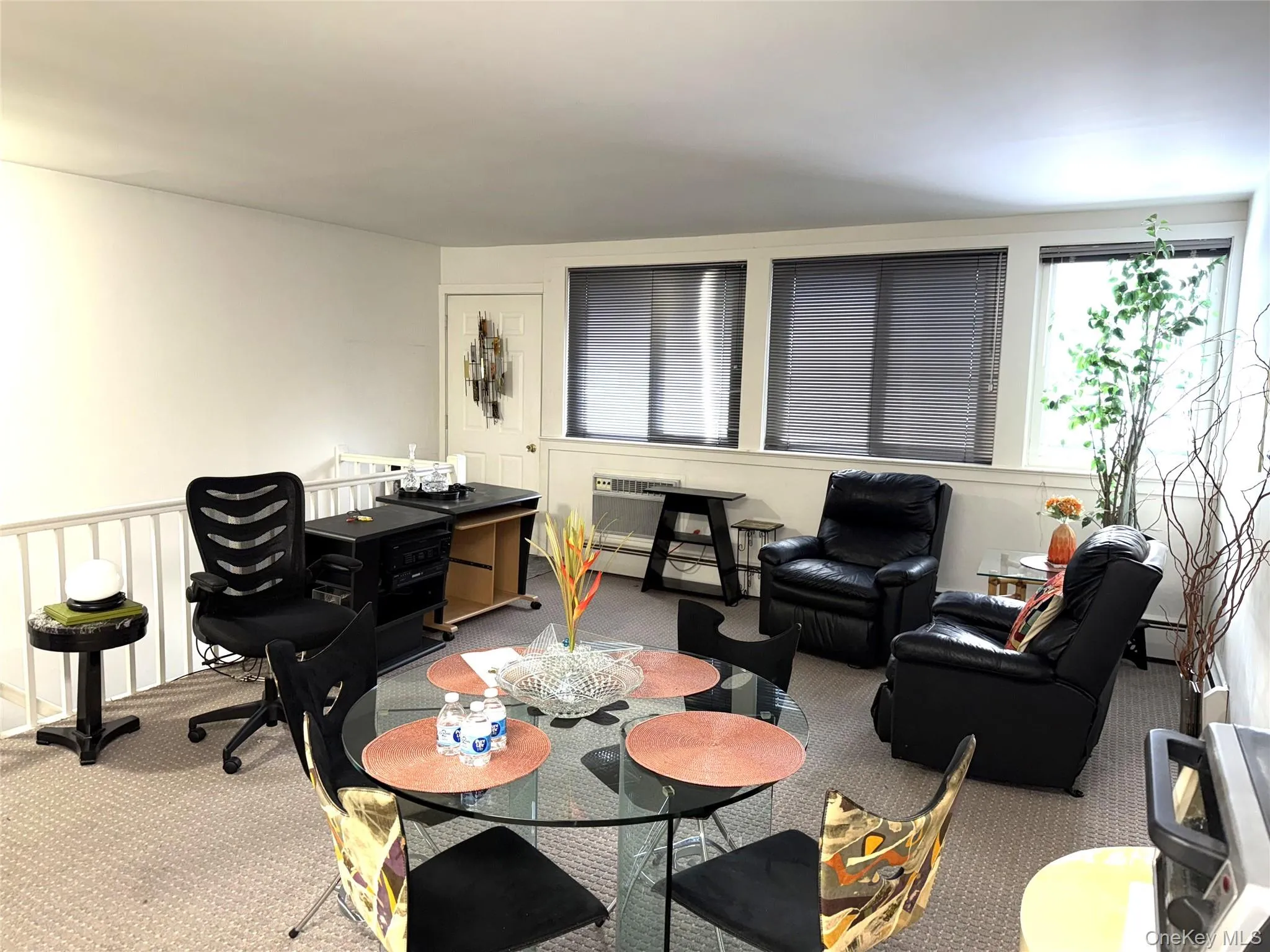 Carpeted dining room with a wall mounted AC Carpeted dining room with a wall mounted AC