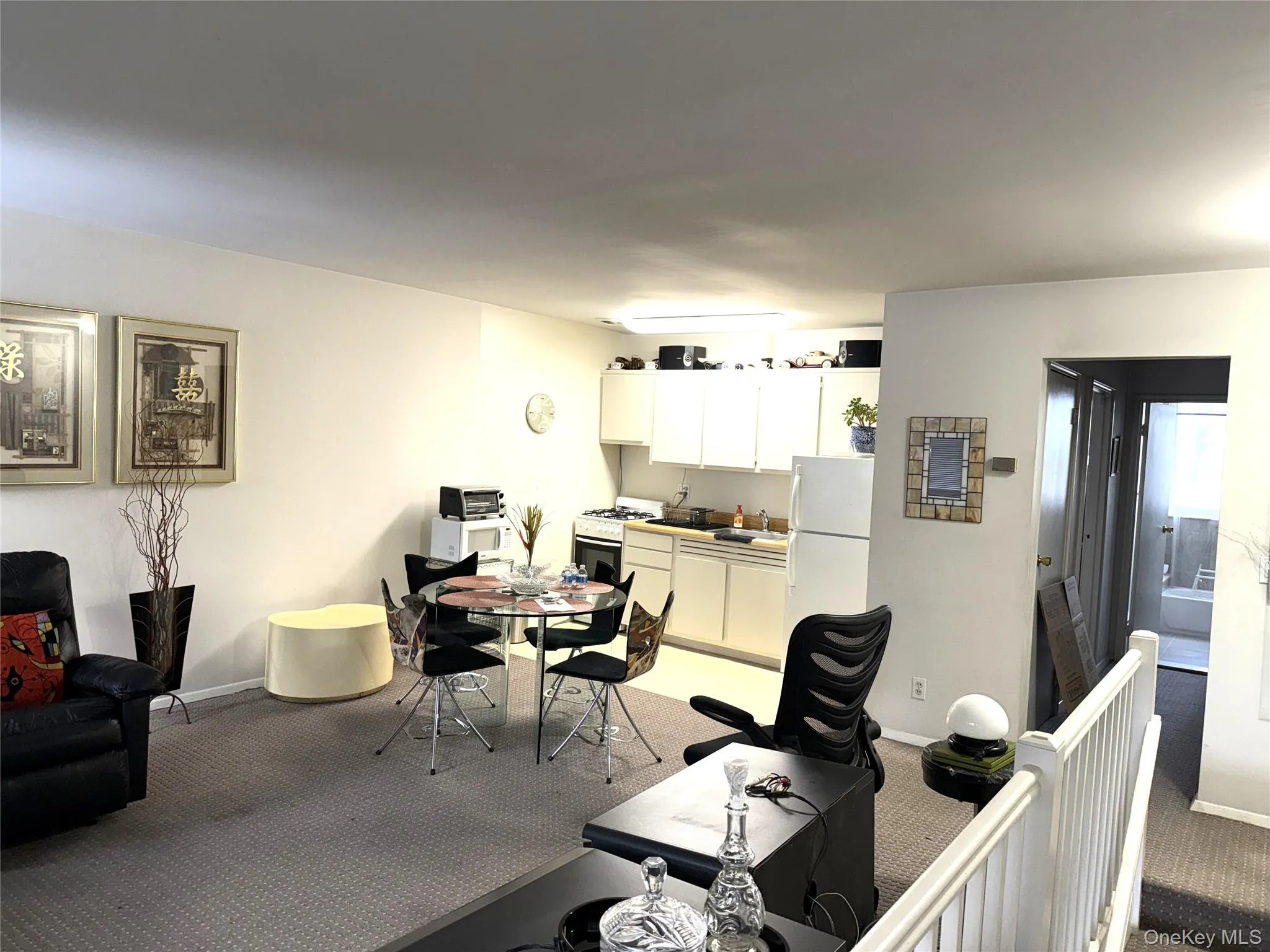 Living area with light carpet and baseboards Living area with light carpet and baseboards