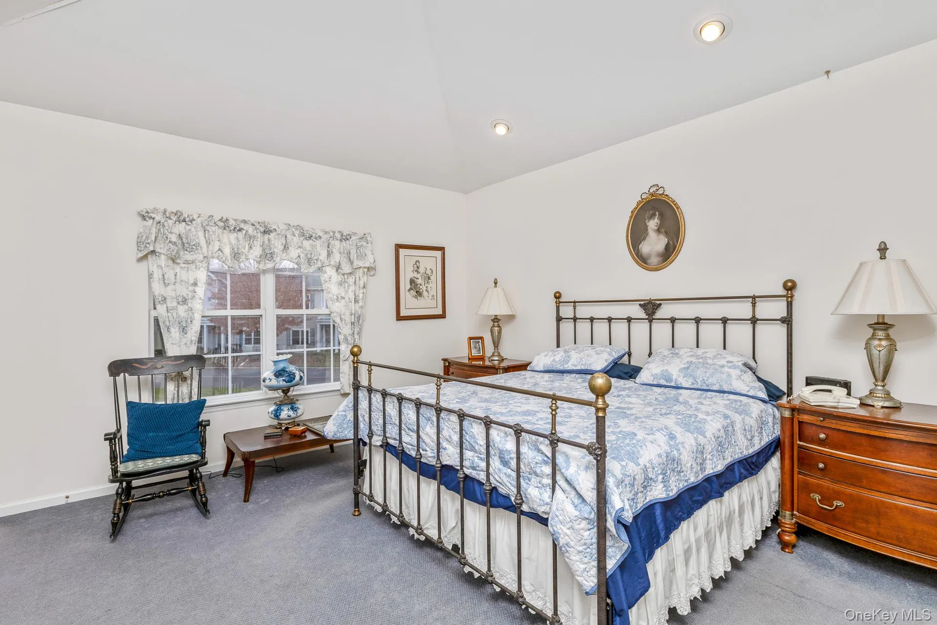 Bedroom featuring carpet floors and lofted ceiling Bedroom featuring carpet floors and lofted ceiling