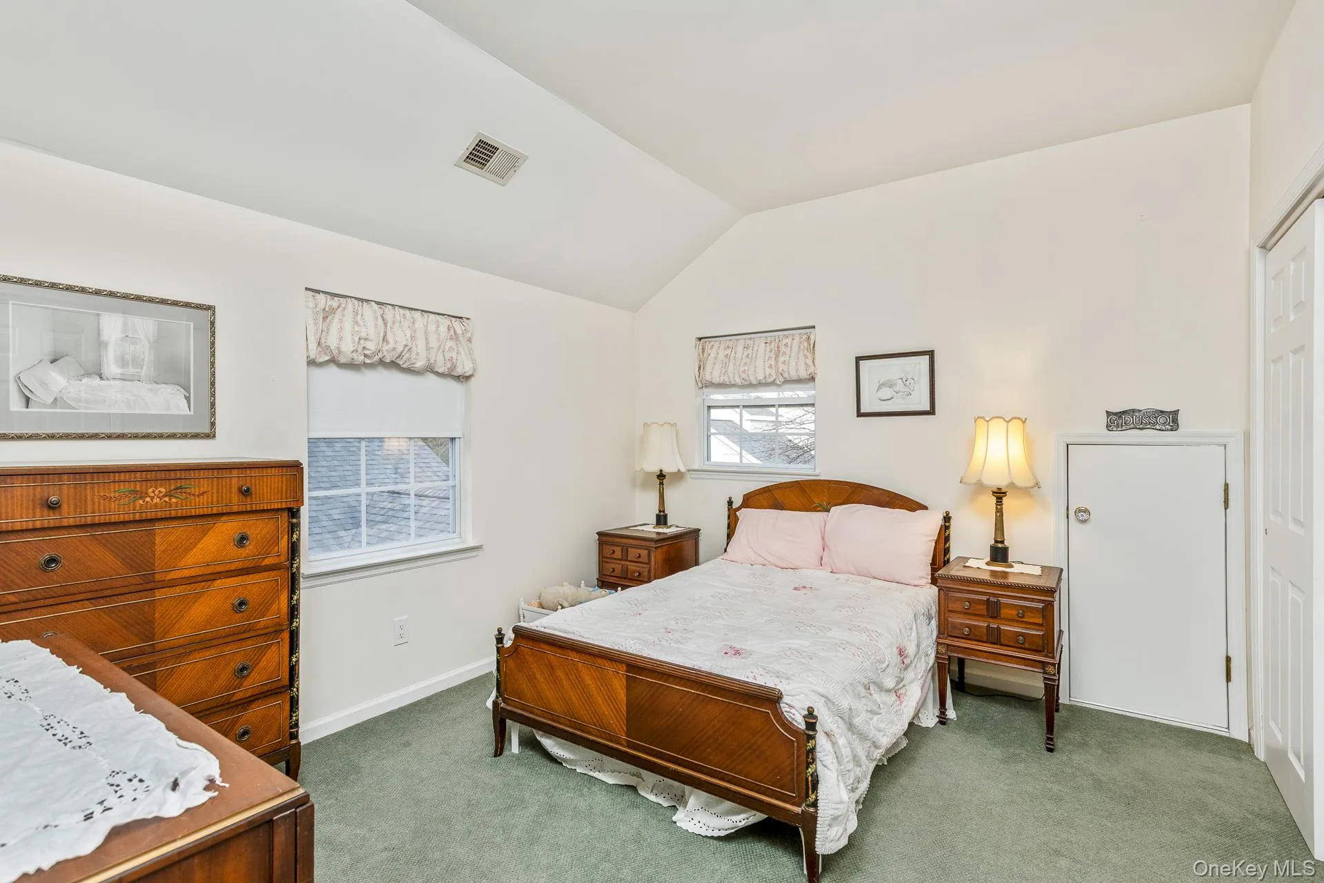 Bedroom with carpet and vaulted ceiling Bedroom with carpet and vaulted ceiling