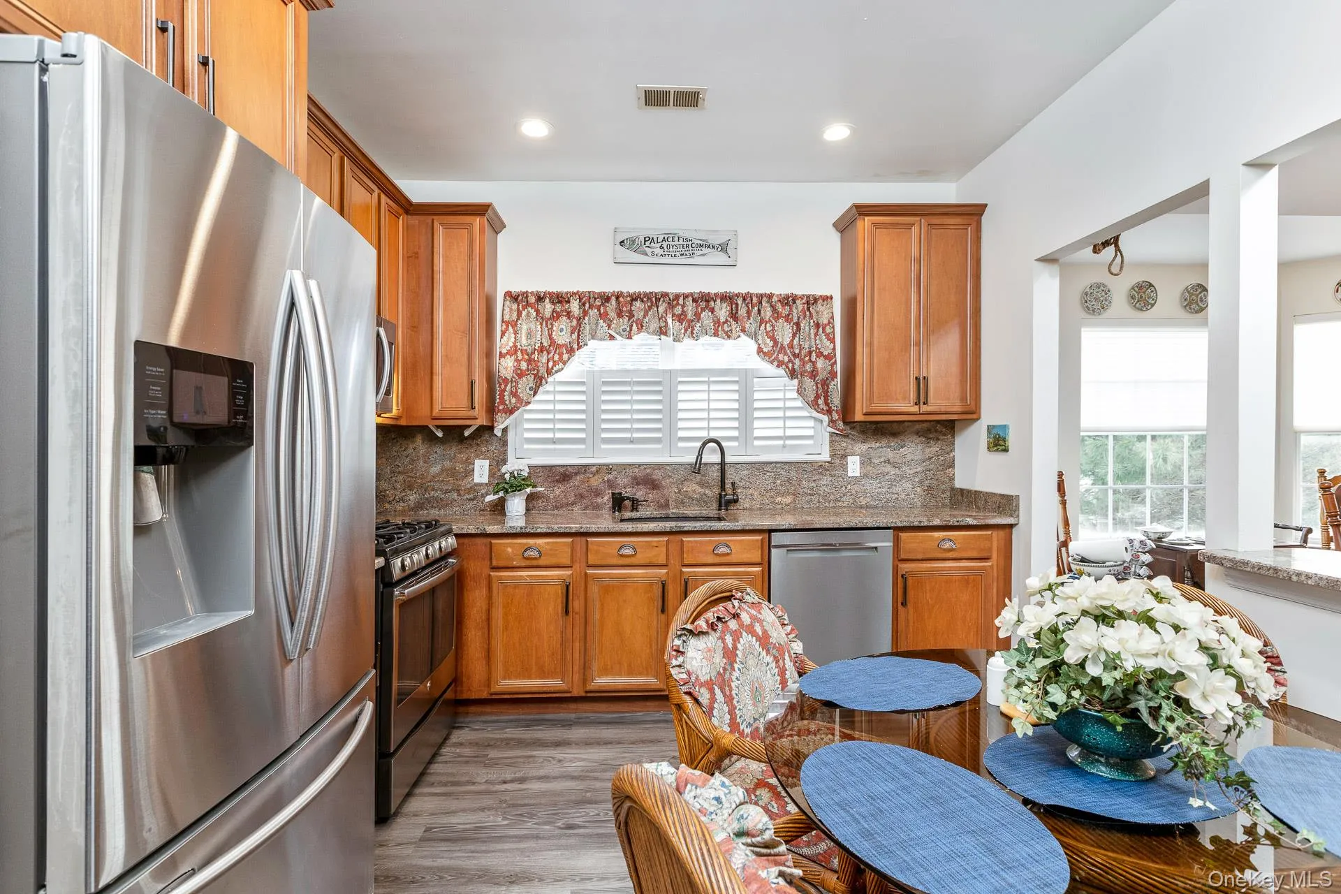 Kitchen with stainless steel appliances, dark stone counters, backsplash, healthy amount of natural light, and recessed lighting Kitchen with stainless steel appliances, dark stone counters, backsplash, healthy amount of natural light, and recessed lighting