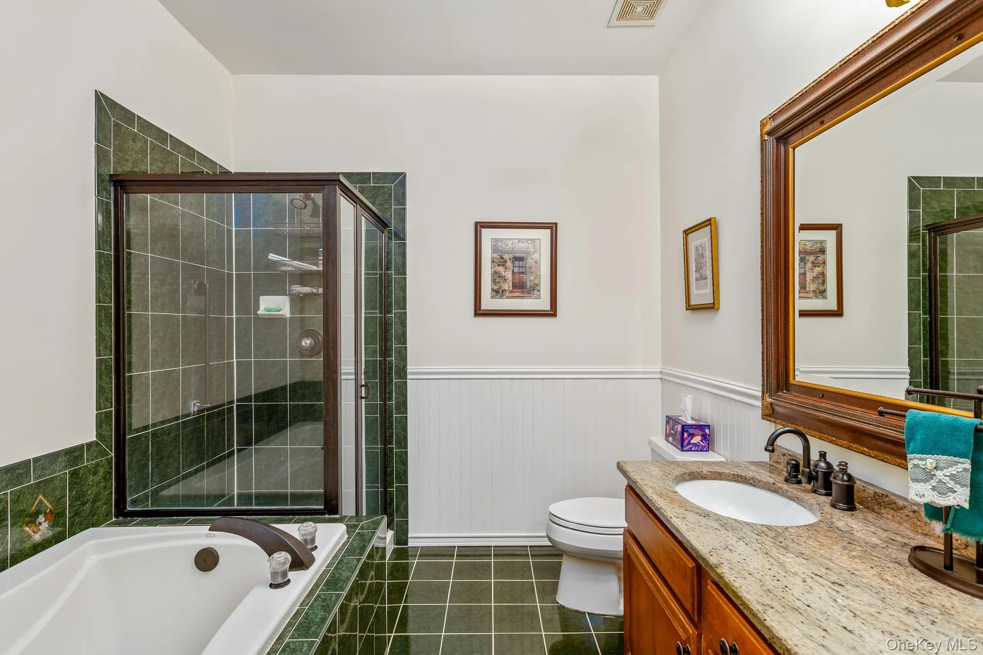 Full bathroom with a bath, vanity, wainscoting, and a shower stall Full bathroom with a bath, vanity, wainscoting, and a shower stall