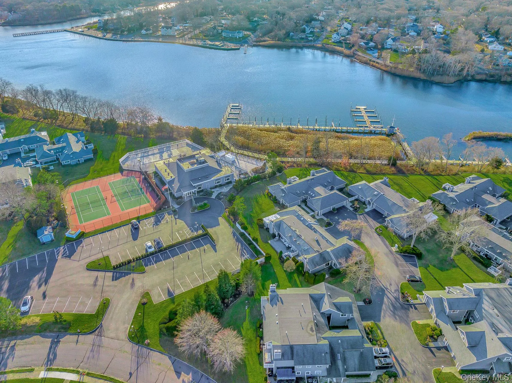 Aerial view of residential area featuring a large body of water Aerial view of residential area featuring a large body of water