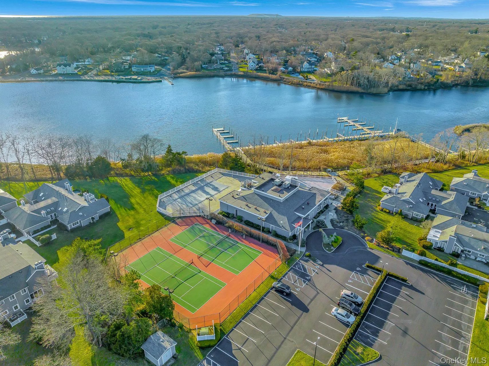 Aerial perspective of suburban area with a nearby body of water Aerial perspective of suburban area with a nearby body of water