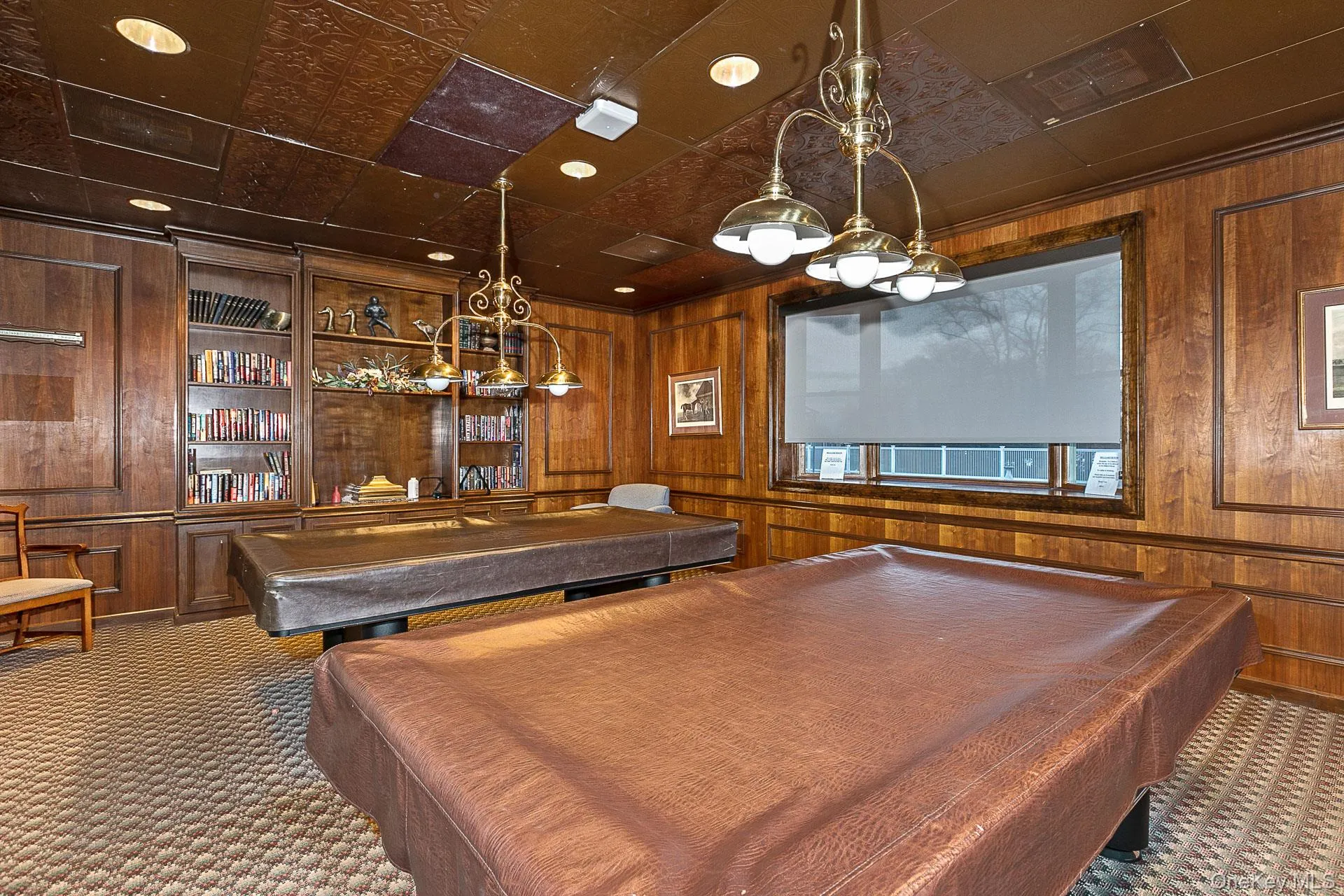 Playroom featuring billiards table, wooden walls, and an ornate ceiling Playroom featuring billiards table, wooden walls, and an ornate ceiling