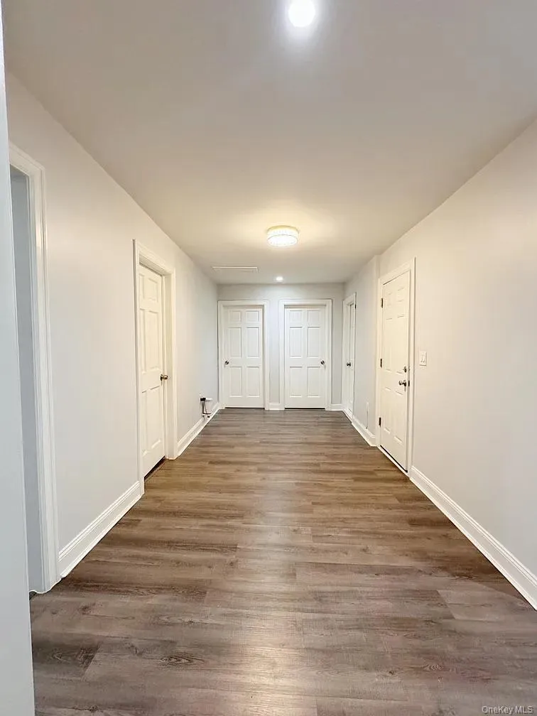Corridor with dark wood-style floors and recessed lighting Corridor with dark wood-style floors and recessed lighting