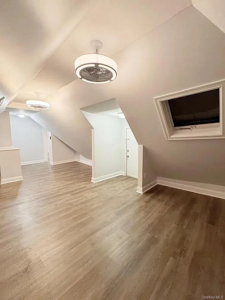 Additional living space with vaulted ceiling and wood finished floors Additional living space with vaulted ceiling and wood finished floors