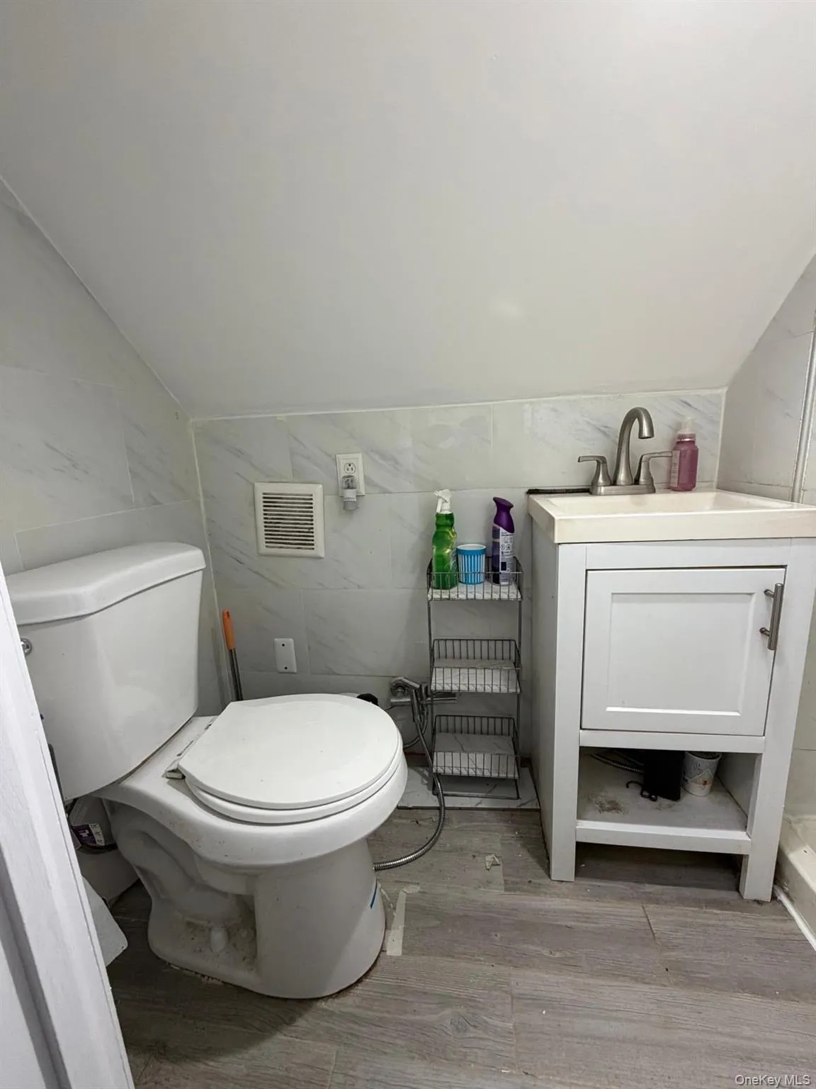 2 ND FLOOR Bathroom featuring vanity, tile walls, and light wood-style floors 2 ND FLOOR Bathroom featuring vanity, tile walls, and light wood-style floors