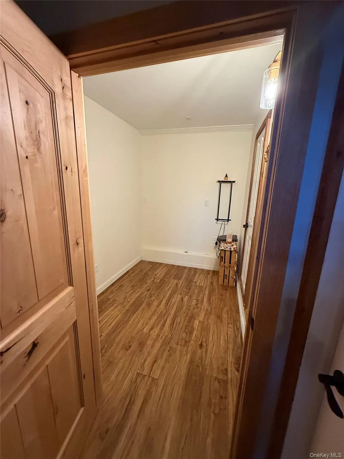 Corridor with wood finished floors and baseboards Corridor with wood finished floors and baseboards