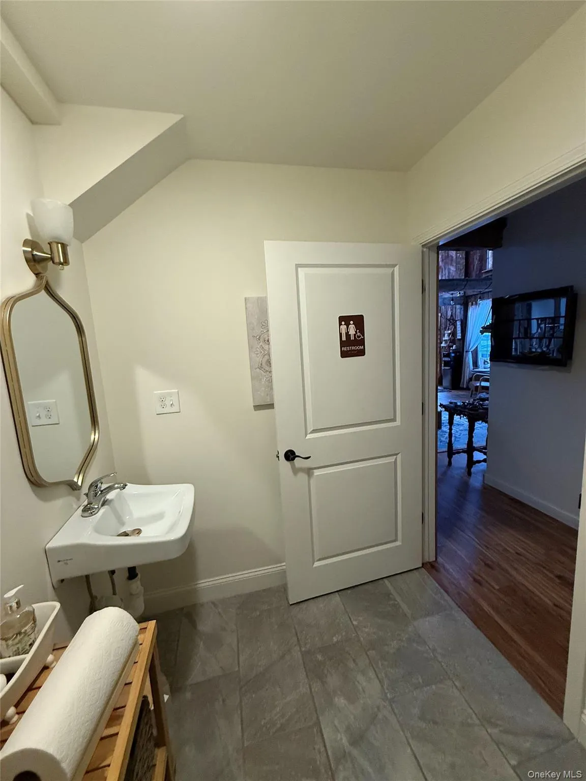 Bathroom featuring baseboards and a sink Bathroom featuring baseboards and a sink