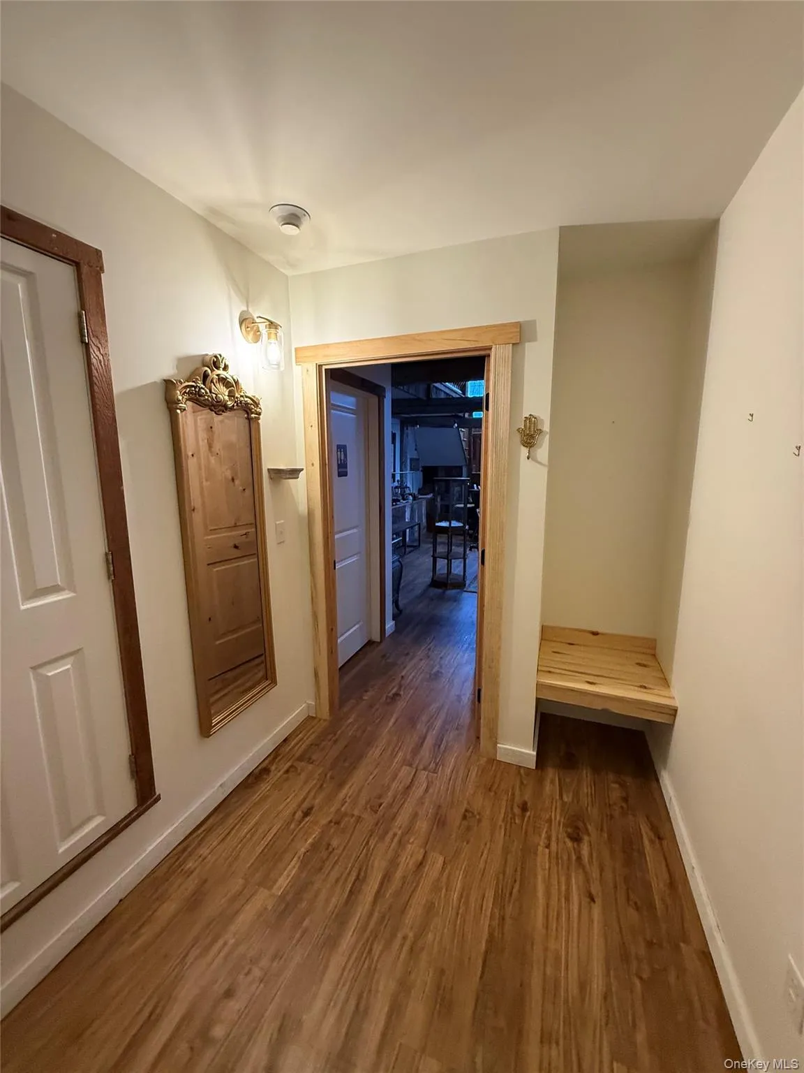 Hall featuring dark wood finished floors and baseboards Hall featuring dark wood finished floors and baseboards