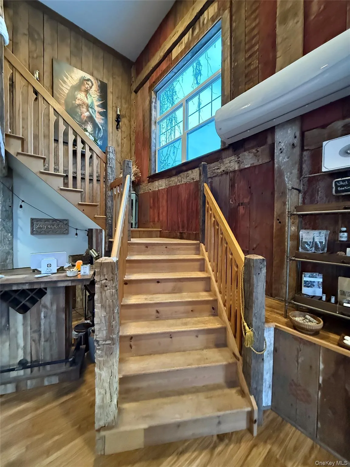 Stairs featuring wood walls, wood finished floors, and a wall unit AC Stairs featuring wood walls, wood finished floors, and a wall unit AC