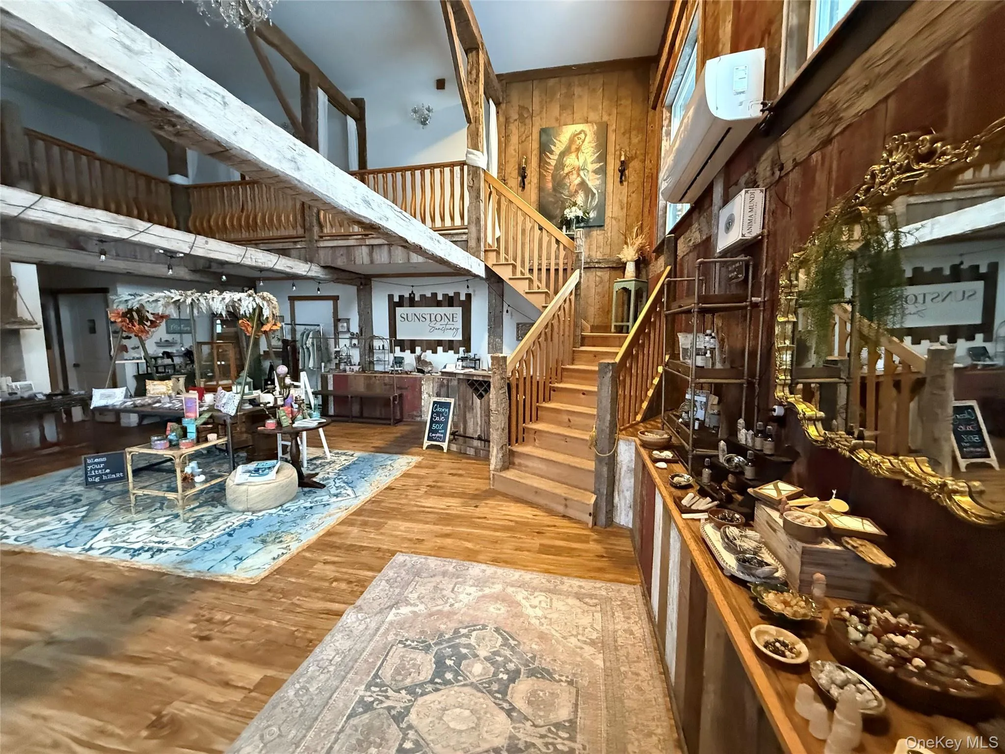 Building lobby featuring a towering ceiling, stairway, and wooden walls Building lobby featuring a towering ceiling, stairway, and wooden walls