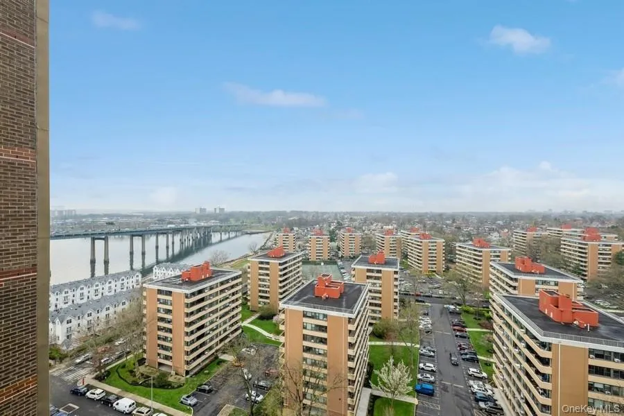 View of urban area with a notable bridge and a large body of water View of urban area with a notable bridge and a large body of water