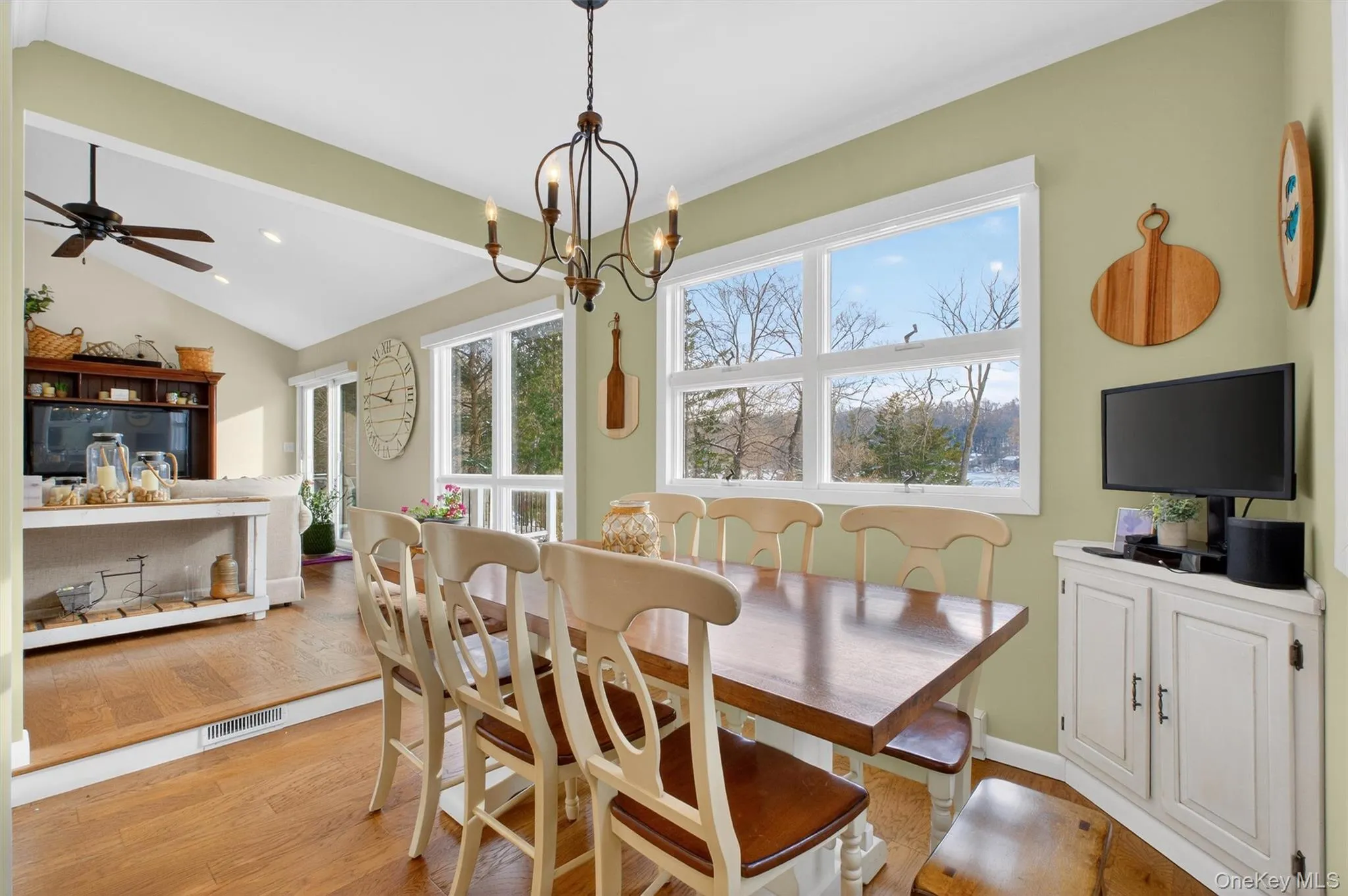 Dining room with light wood-type flooring, a chandelier, and recessed lighting Dining room with light wood-type flooring, a chandelier, and recessed lighting