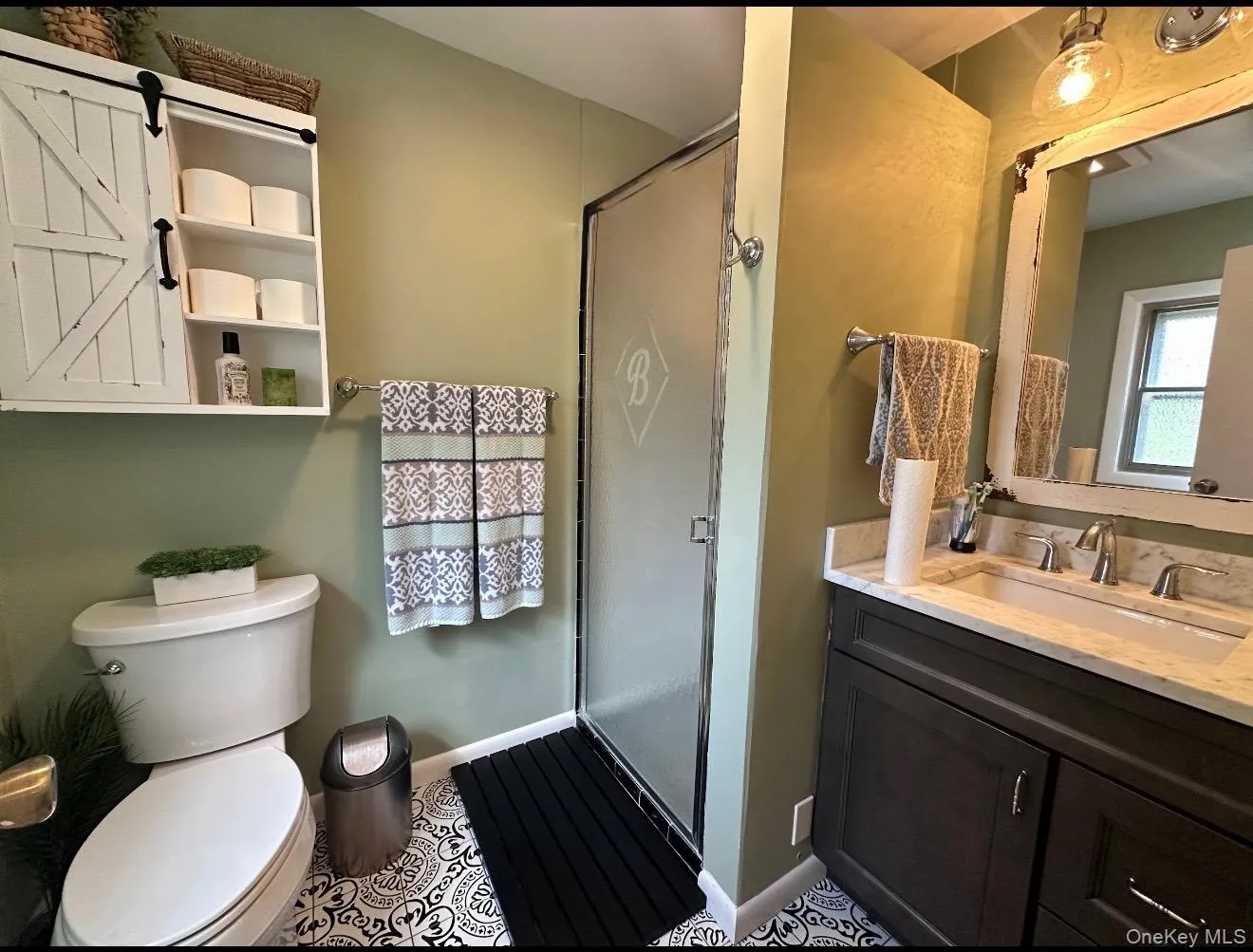 Bathroom with vanity and a stall shower Bathroom with vanity and a stall shower