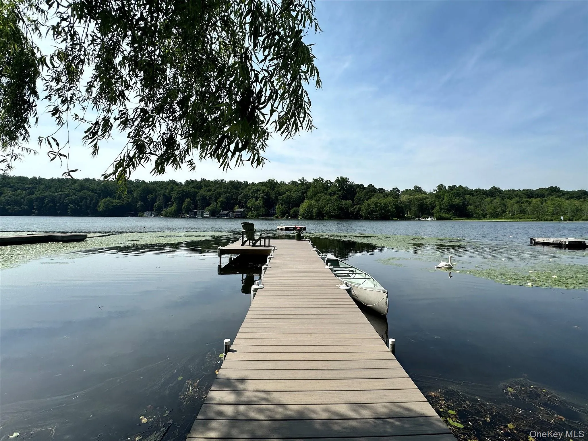 Dock featuring a wooded view and a water view Dock featuring a wooded view and a water view