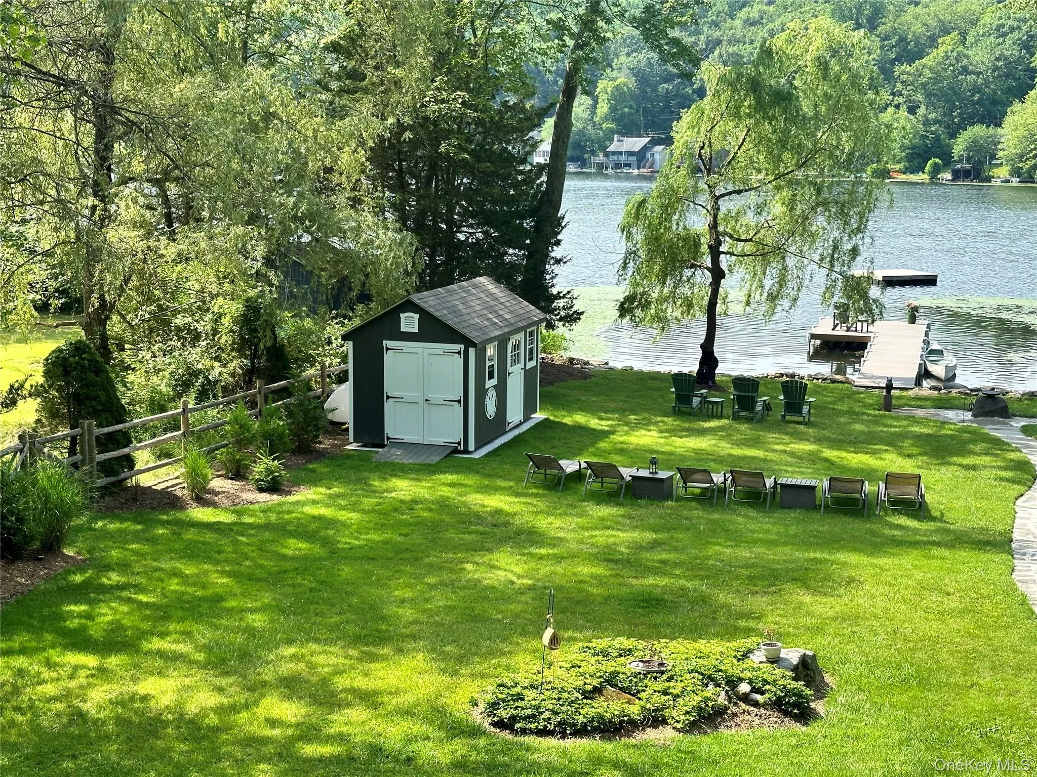 View of yard with a shed and a water view View of yard with a shed and a water view