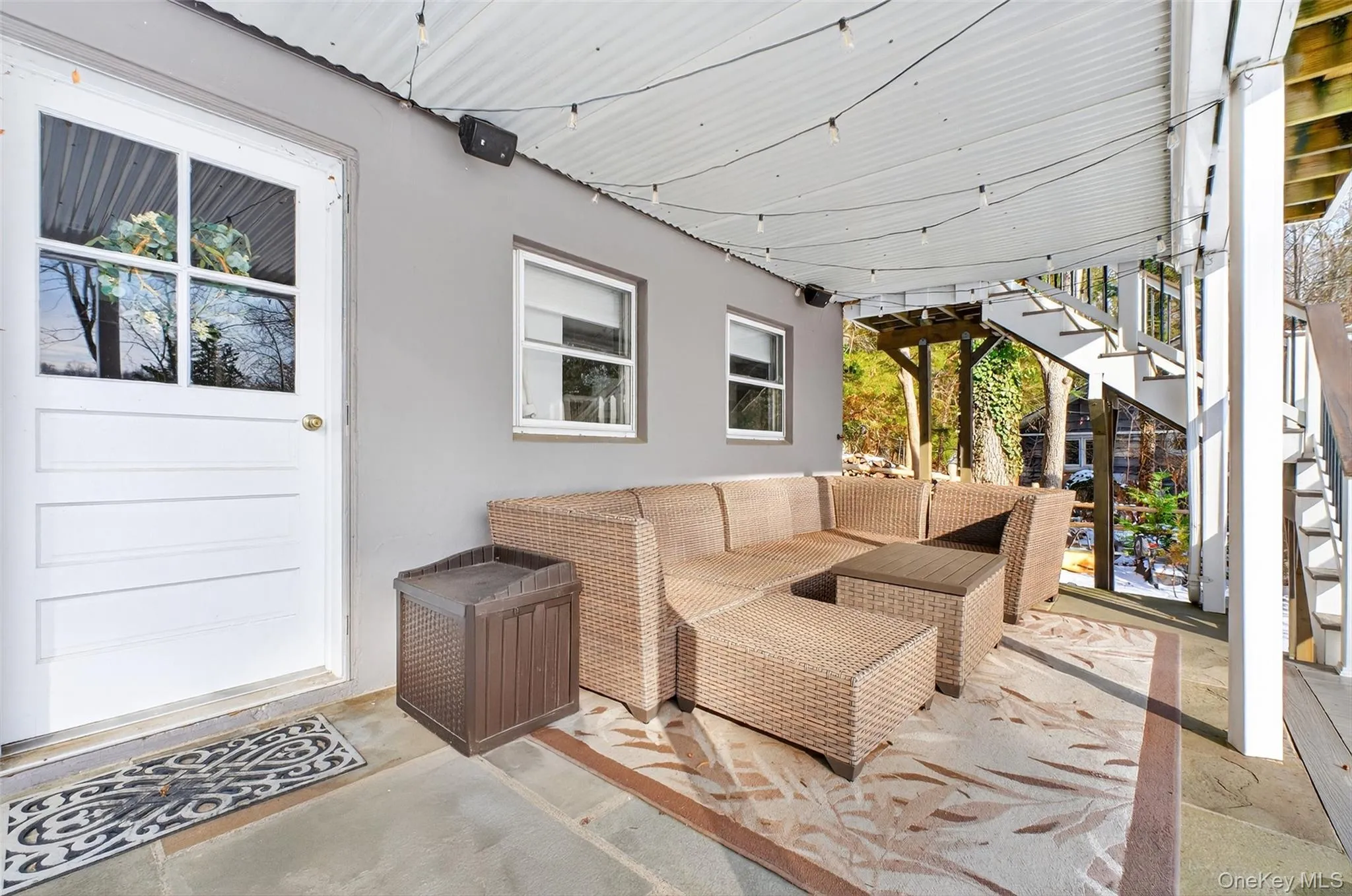 Wooden deck featuring an outdoor hangout area, a patio, and stairway Wooden deck featuring an outdoor hangout area, a patio, and stairway