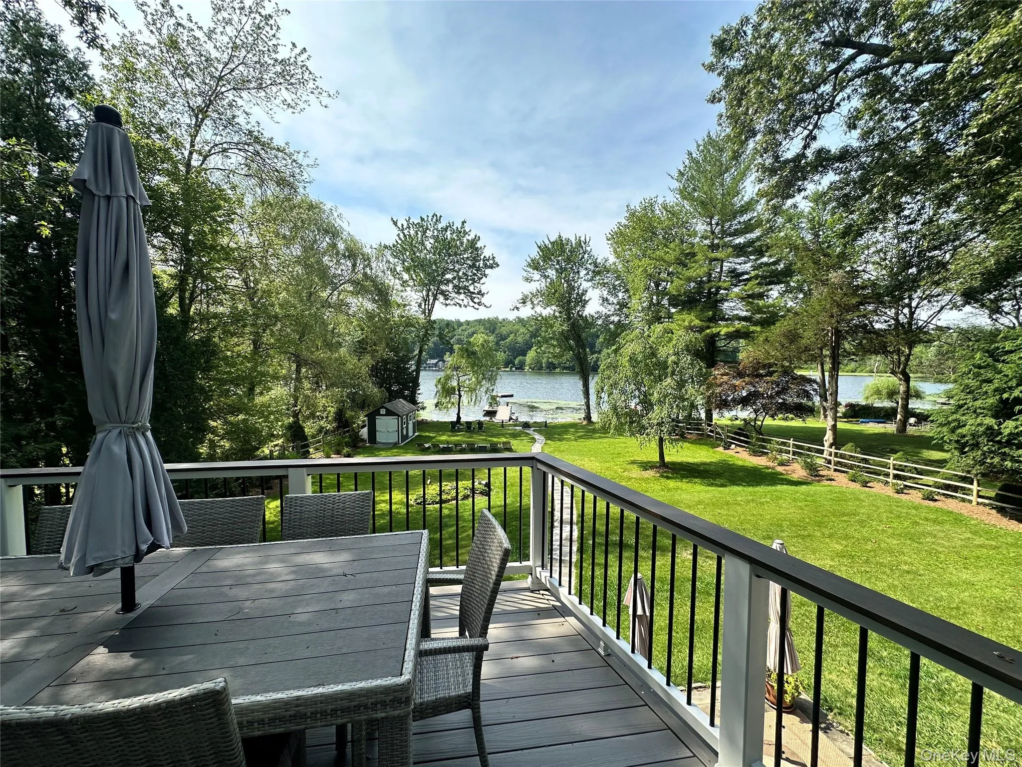 Wooden deck featuring a water view and outdoor dining area Wooden deck featuring a water view and outdoor dining area
