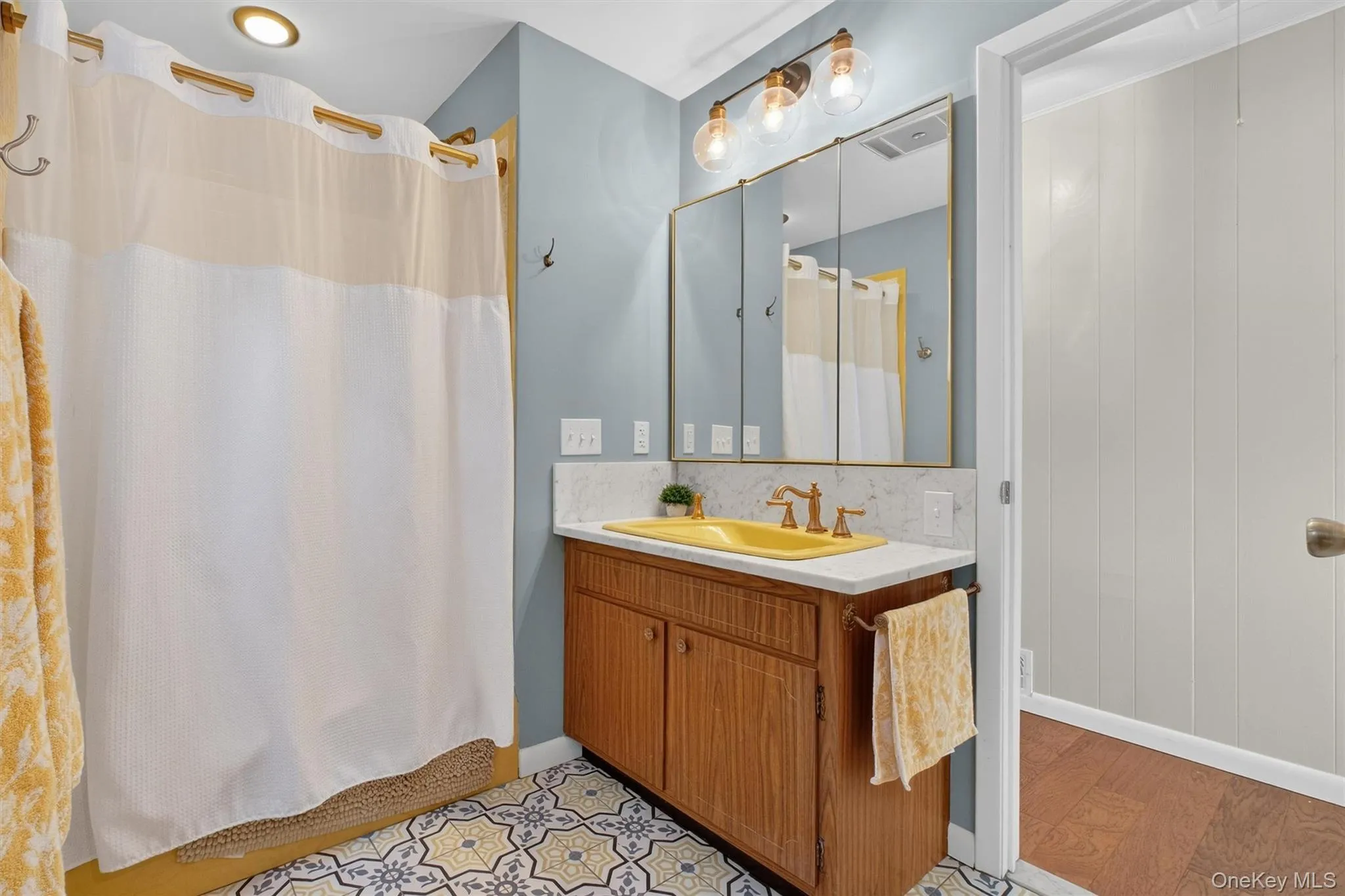 Bathroom with curtained shower and vanity Bathroom with curtained shower and vanity