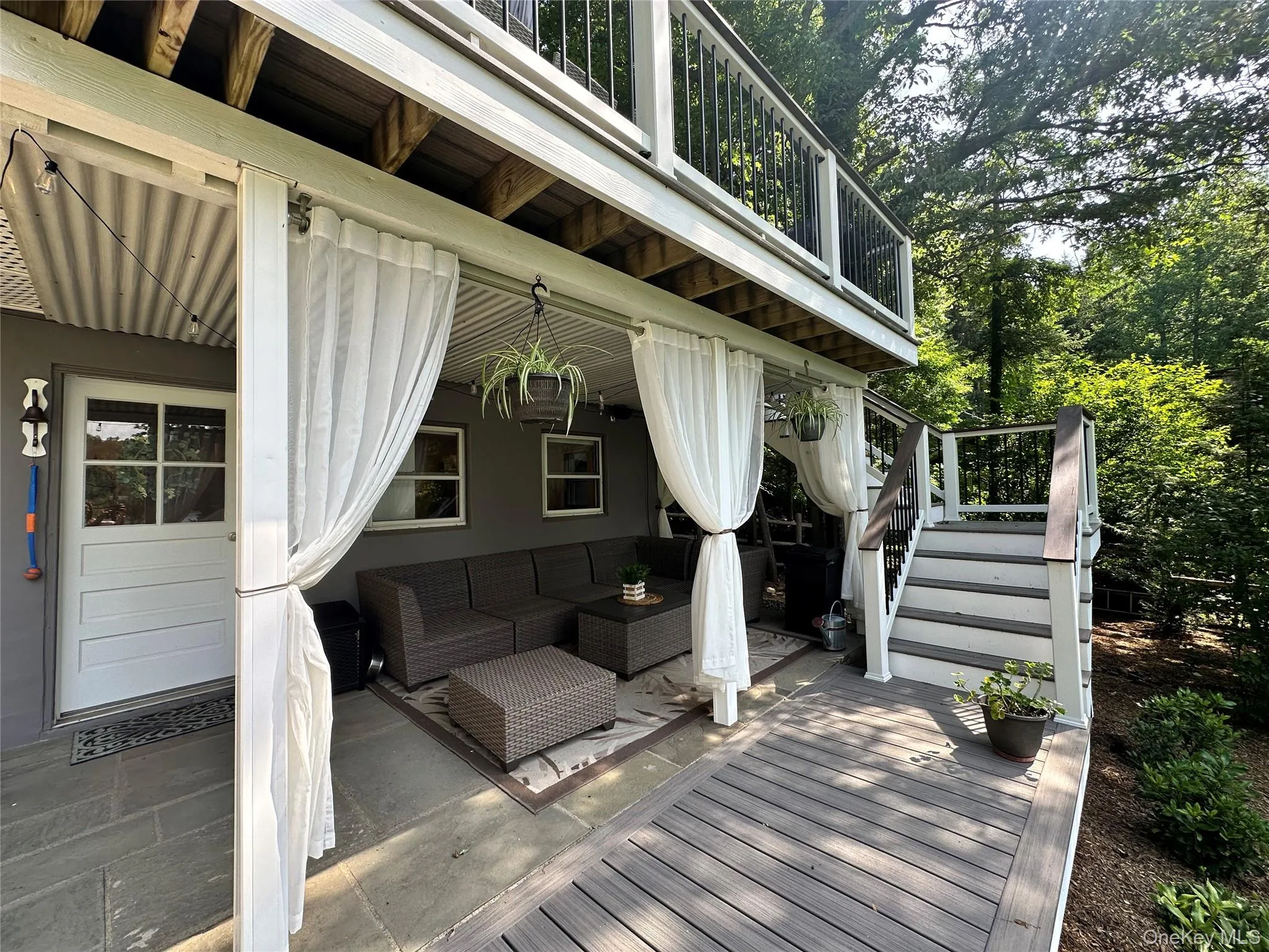 Deck with stairway, outdoor lounge area, and a patio Deck with stairway, outdoor lounge area, and a patio