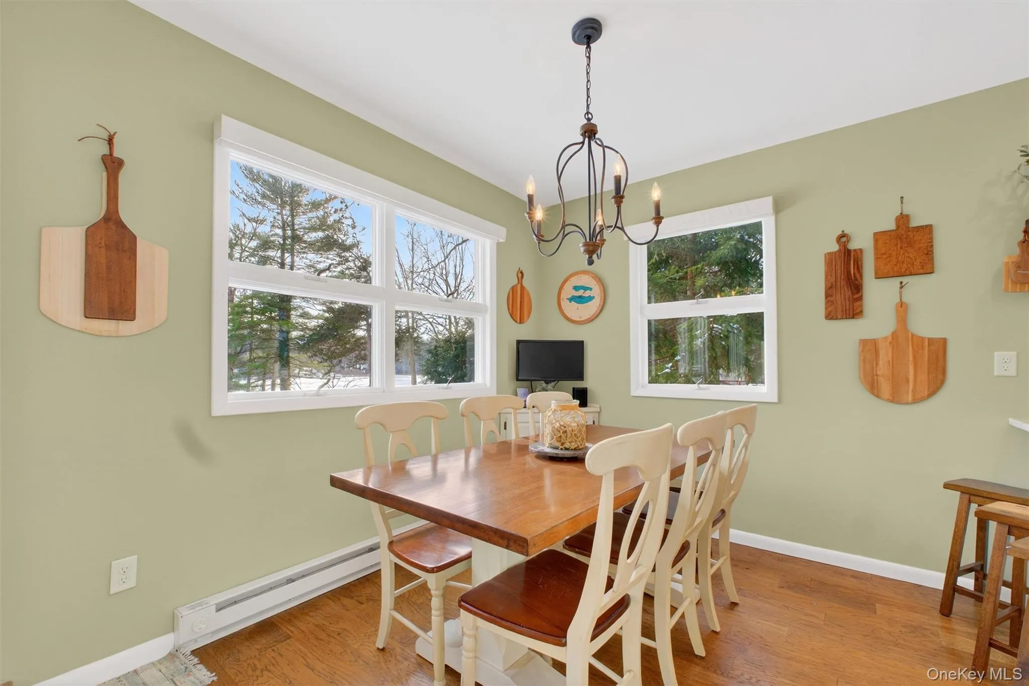 Dining room with baseboard heating, healthy amount of natural light, and light wood-style flooring Dining room with baseboard heating, healthy amount of natural light, and light wood-style flooring