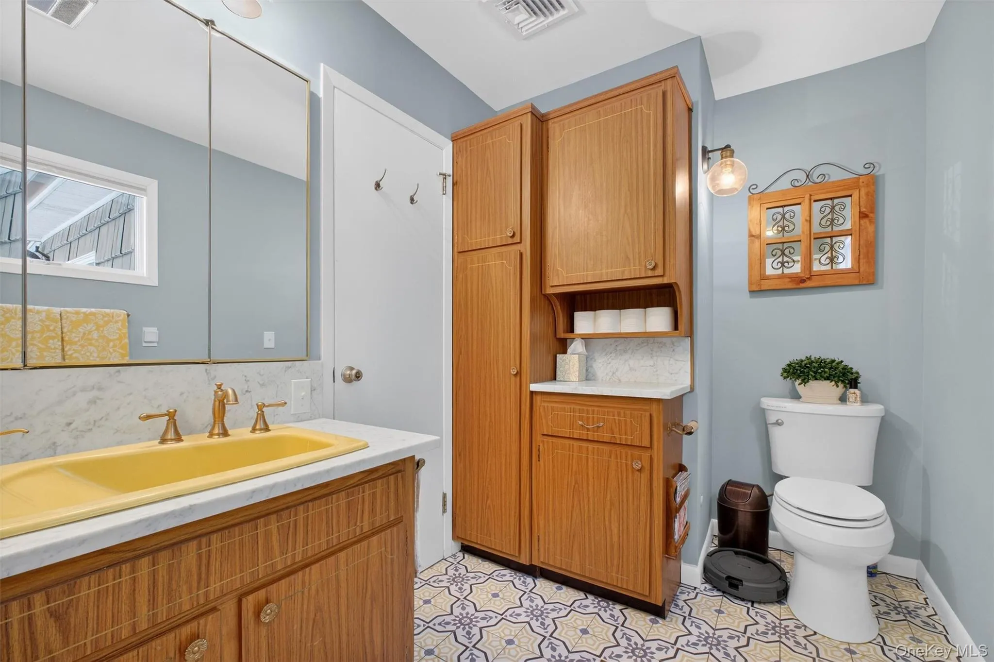 Half bathroom with tasteful backsplash, vanity, and light tile patterned floors Half bathroom with tasteful backsplash, vanity, and light tile patterned floors