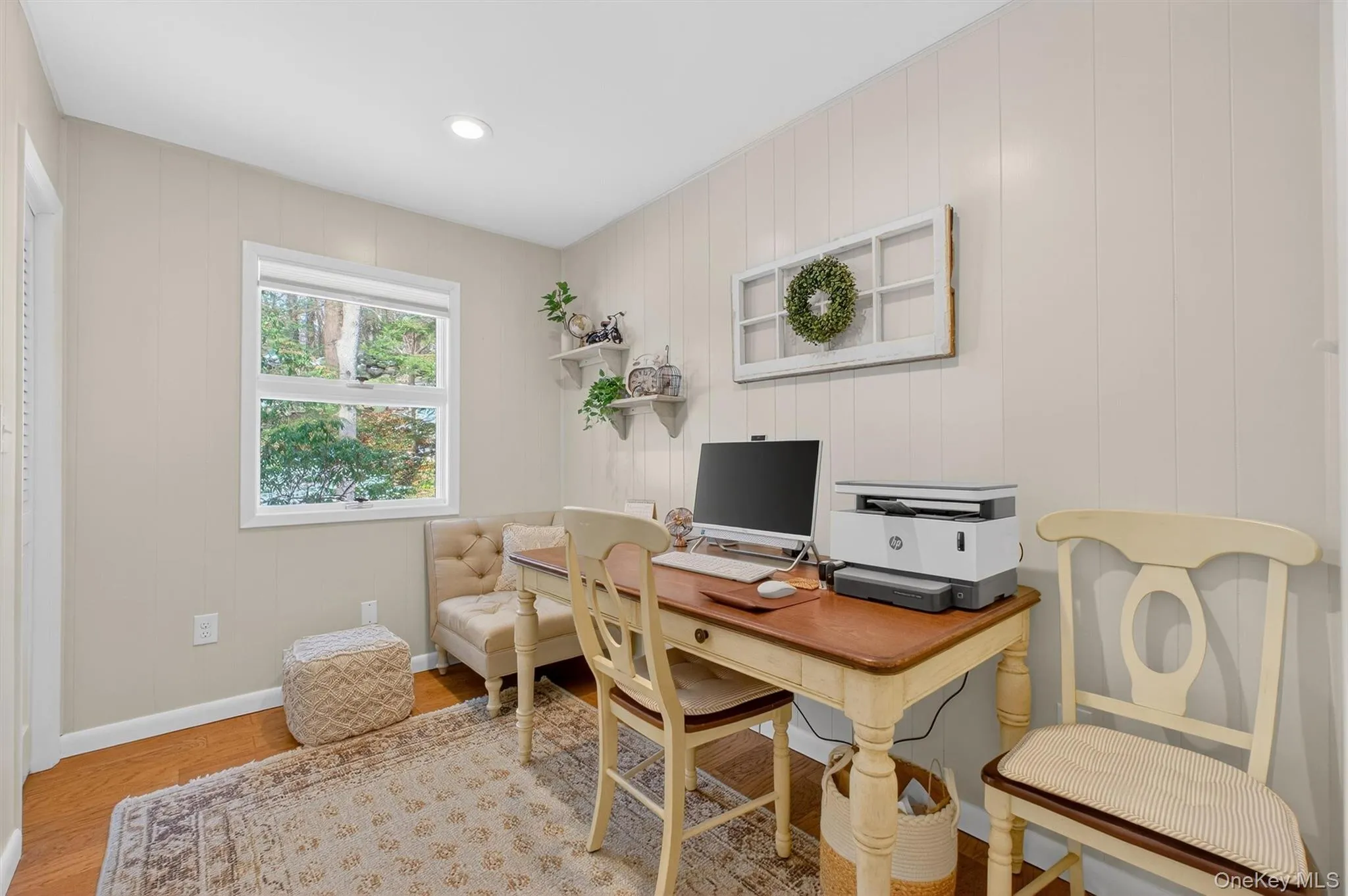Home office featuring wooden walls, recessed lighting, and light wood-style flooring Home office featuring wooden walls, recessed lighting, and light wood-style flooring