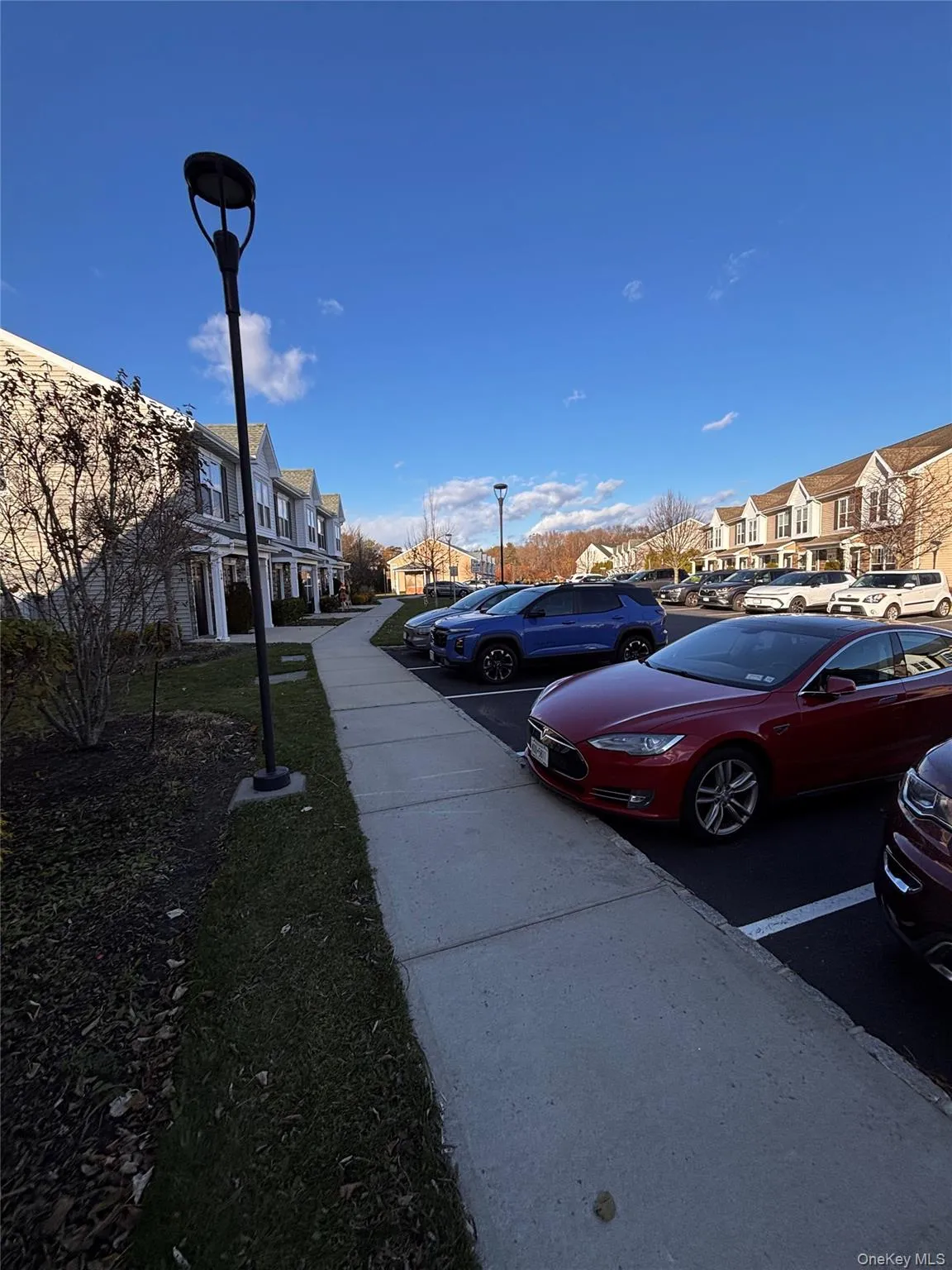 View of road with a residential view, sidewalks, and street lights View of road with a residential view, sidewalks, and street lights
