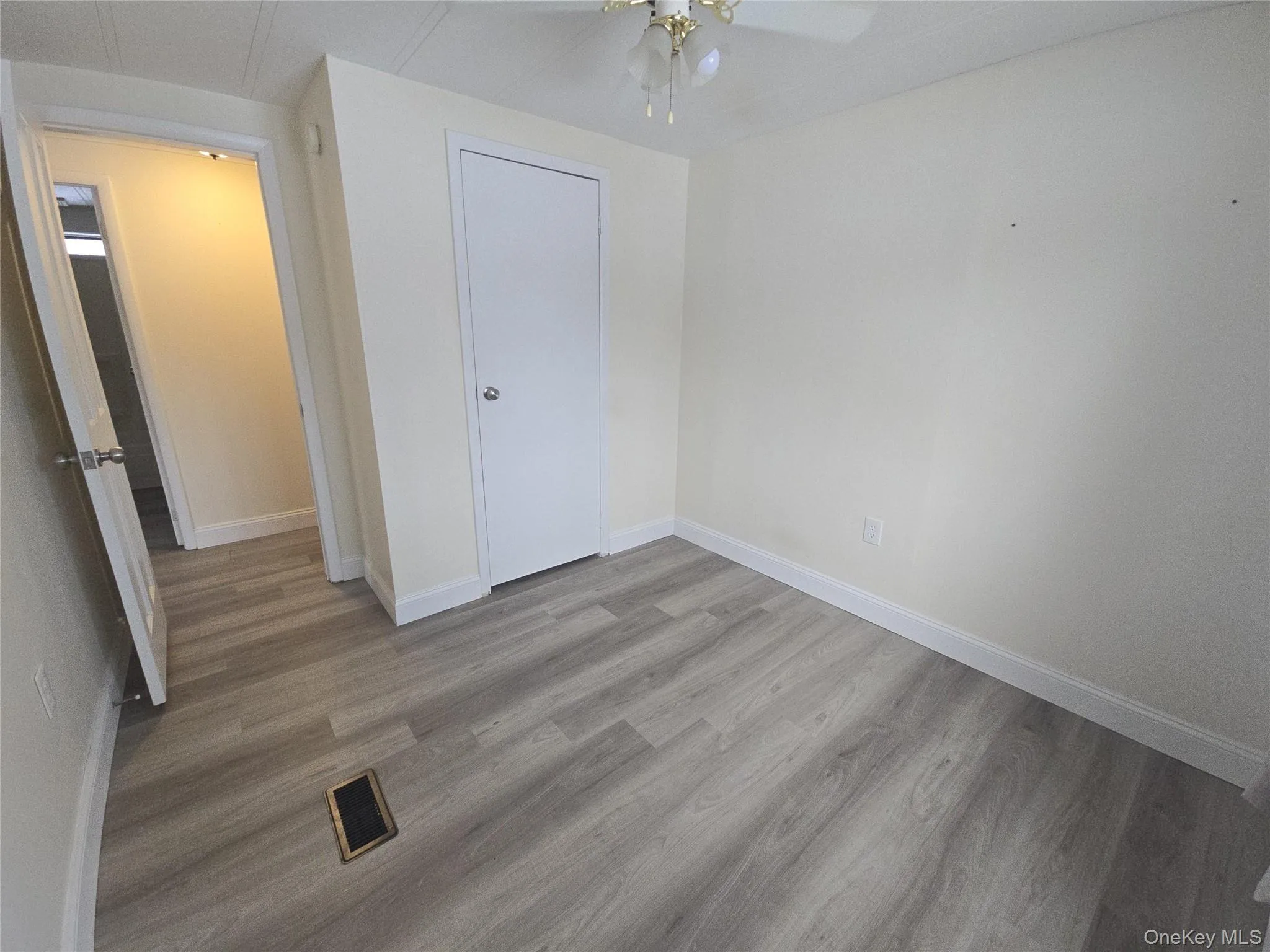 Unfurnished bedroom featuring light wood-type flooring and a ceiling fan Unfurnished bedroom featuring light wood-type flooring and a ceiling fan