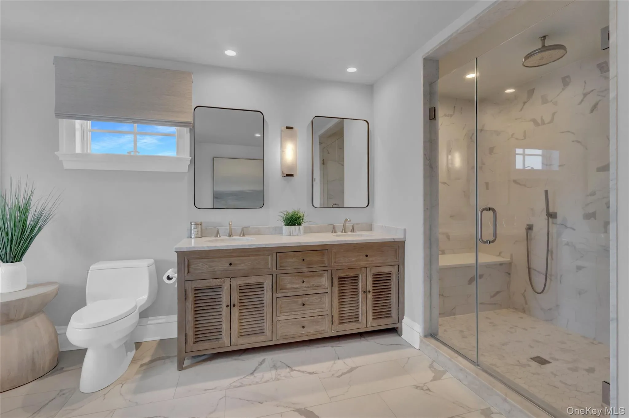 Full bath with double vanity, healthy amount of natural light, a marble finish shower, light marble finish flooring, and recessed lighting Full bath with double vanity, healthy amount of natural light, a marble finish shower, light marble finish flooring, and recessed lighting