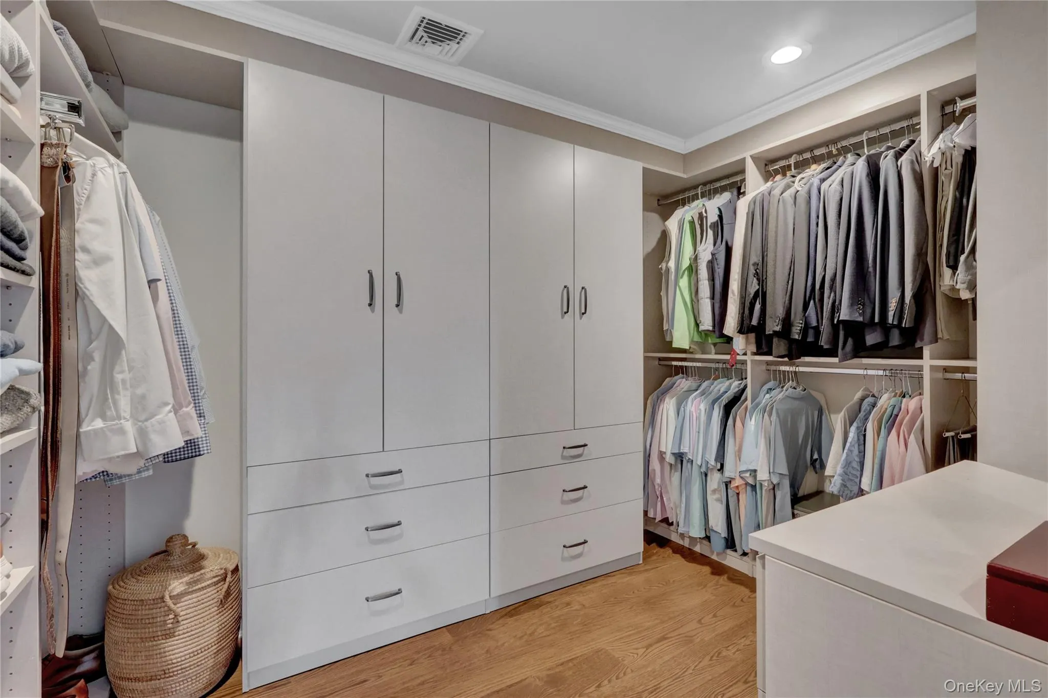 Walk in closet with light wood finished floors Walk in closet with light wood finished floors