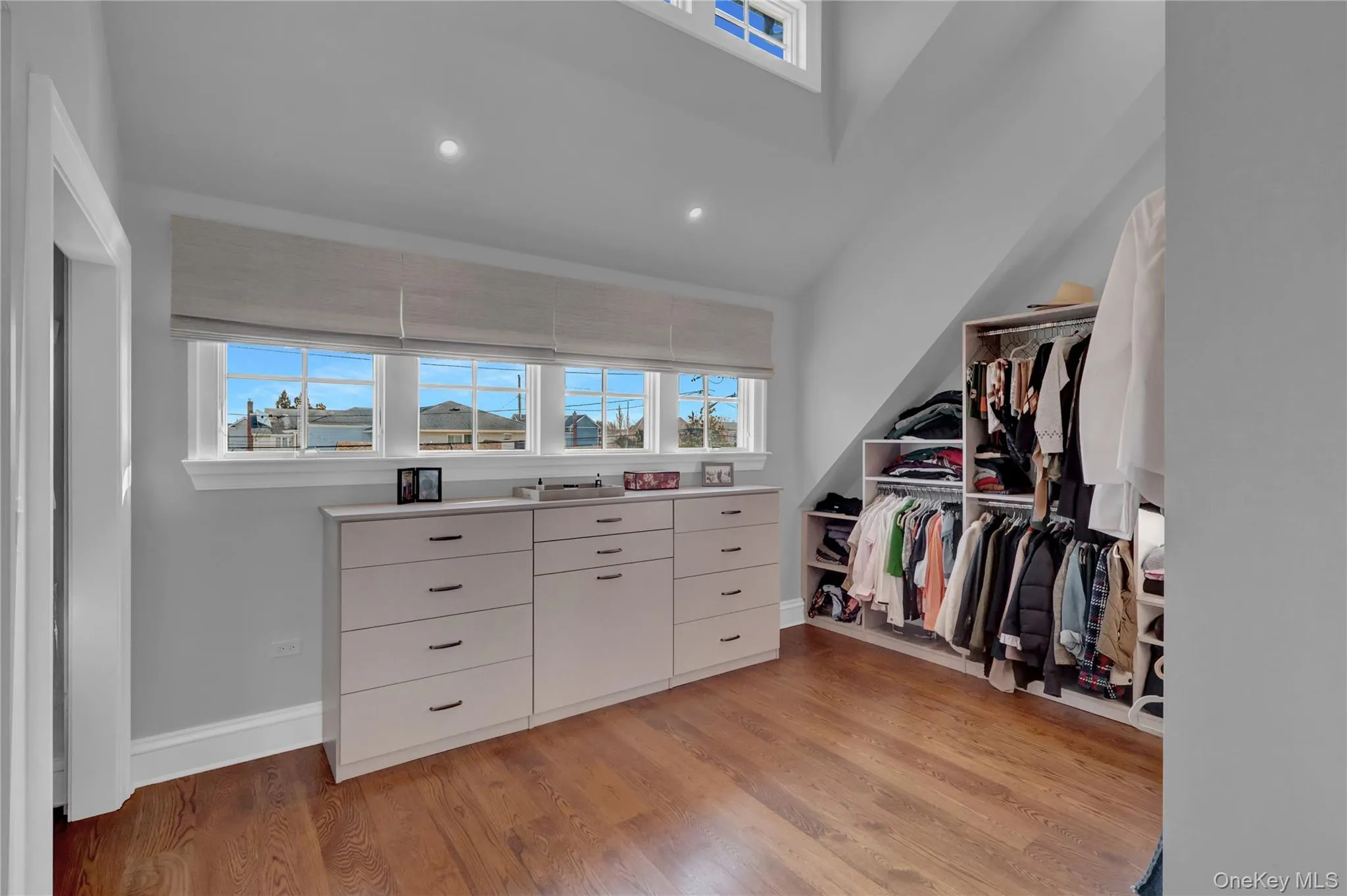 Spacious closet featuring light wood-style floors Spacious closet featuring light wood-style floors