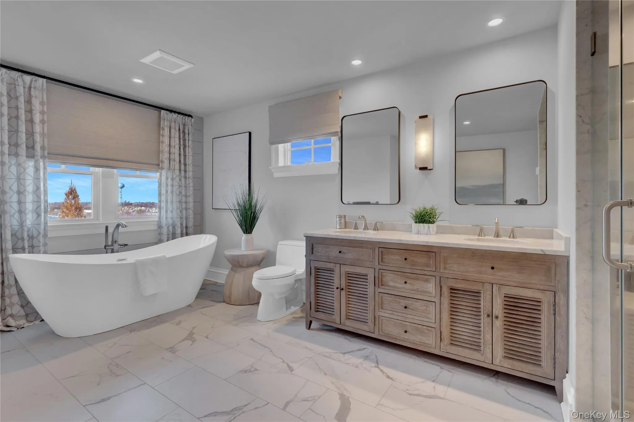 Full bath with a soaking tub, double vanity, light marble finish floors, recessed lighting, and a shower stall Full bath with a soaking tub, double vanity, light marble finish floors, recessed lighting, and a shower stall