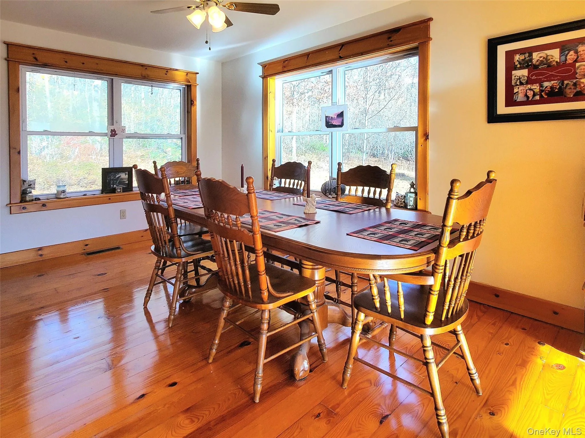 Dining room with natural light from big windows, hardwood floors and wood detail Dining room with natural light from big windows, hardwood floors and wood detail