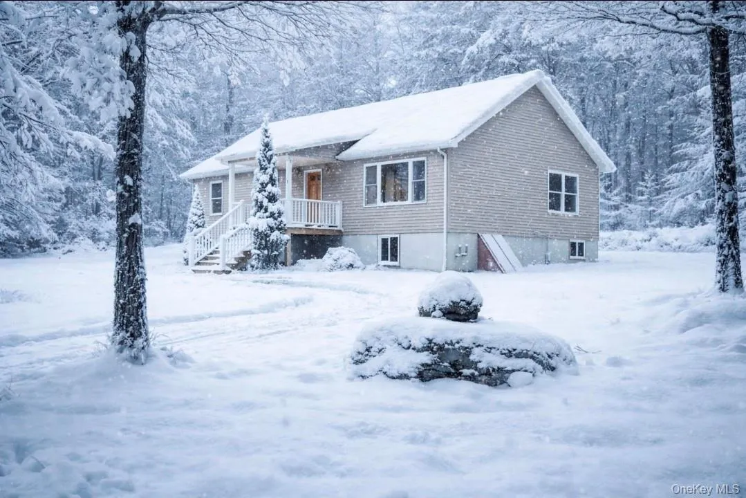 View of front of house with covered porch. AI edited to have snow. View of front of house with covered porch. AI edited to have snow.